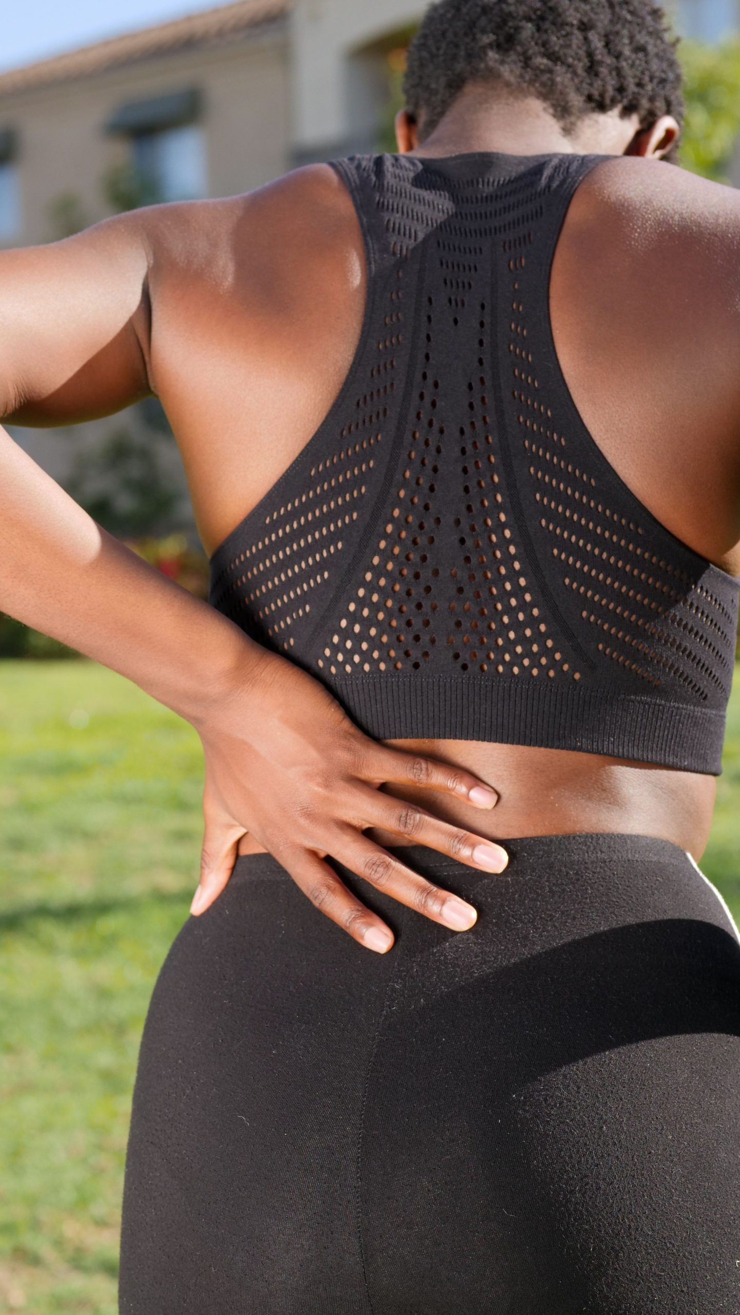 A person holding their lower back